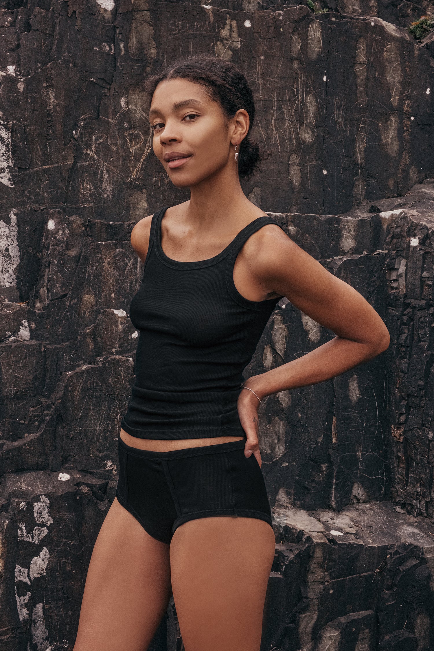 Merino wool top on a model showcasing comfort and style in a natural setting.